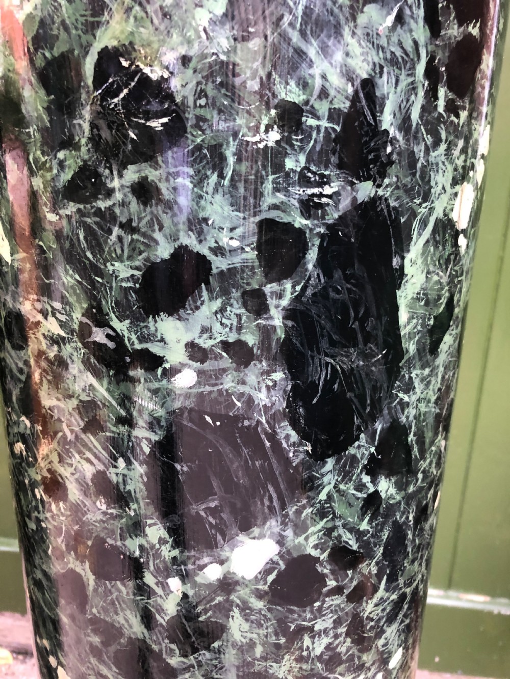 A pair of tall mid-19th century cylindrical wooden display columns painted in a green and black faux verde antico marble finish with square bases. View X