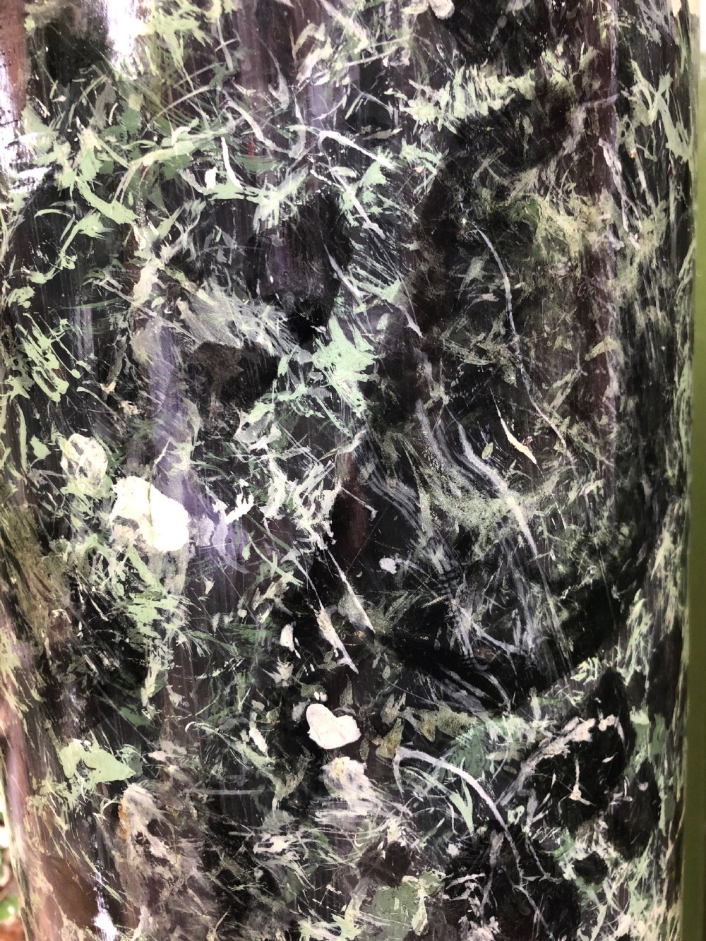 A pair of tall mid-19th century cylindrical wooden display columns painted in a green and black faux verde antico marble finish with square bases. View XIV