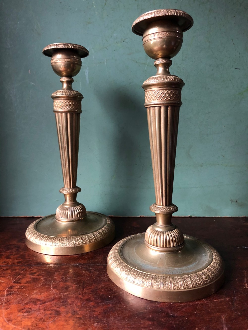 A pair of early 19th-century French Charles X period gilded bronze ormolu candlesticks with fluted columns and detailed engine-turned bases. View III
