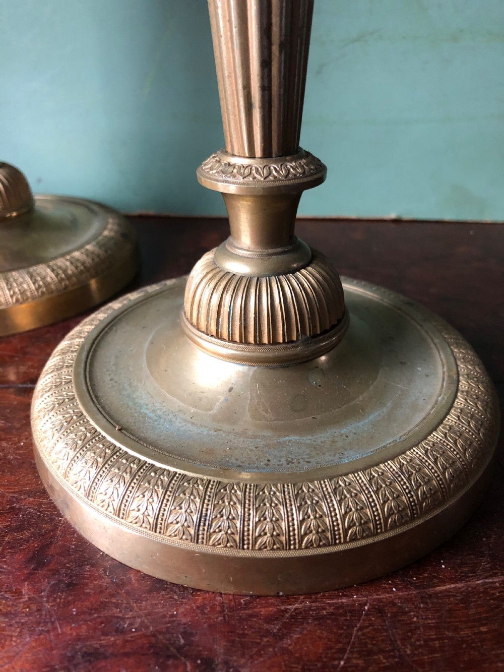 A pair of early 19th-century French Charles X period gilded bronze ormolu candlesticks with fluted columns and detailed engine-turned bases. View IV