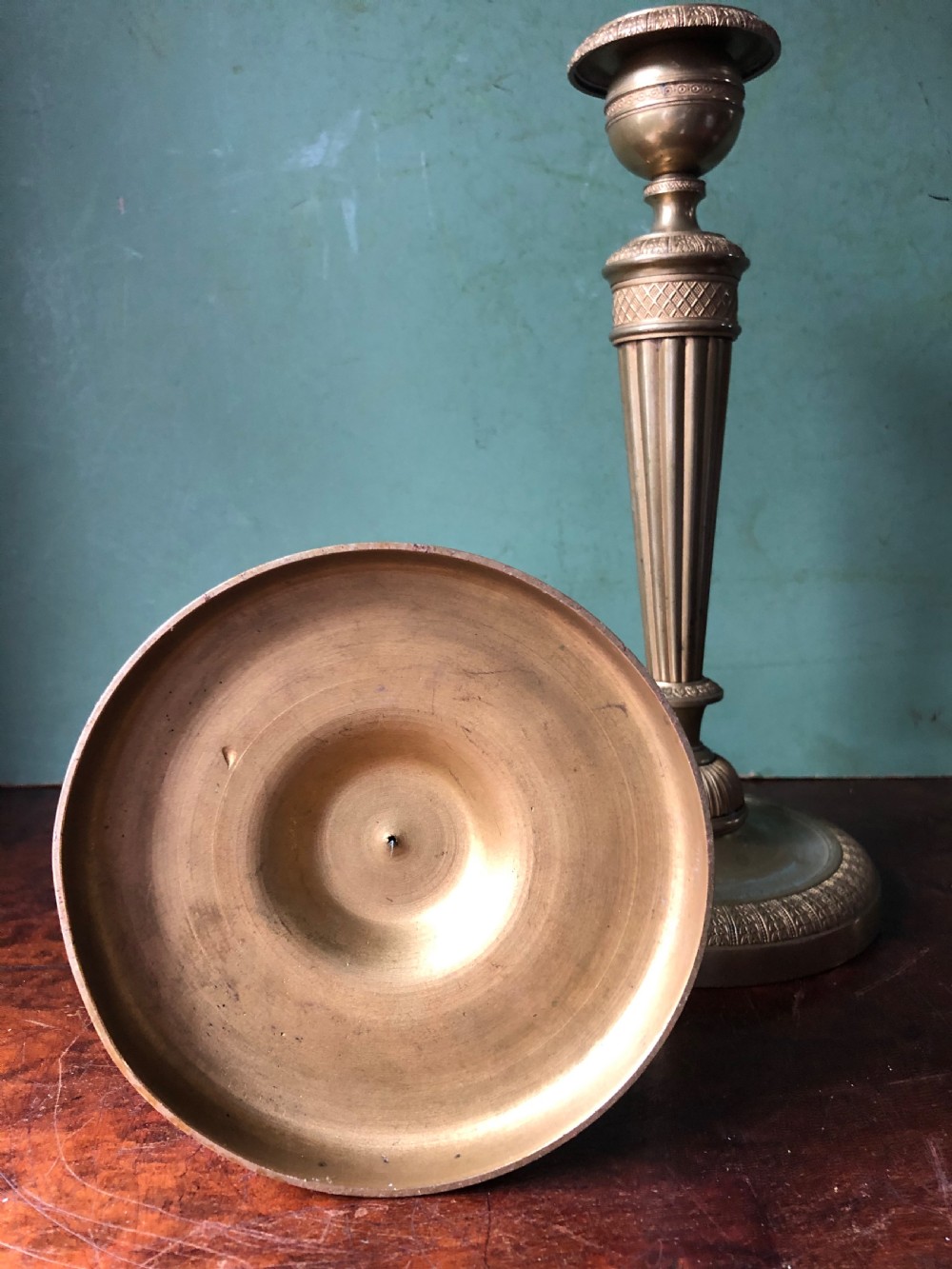 A pair of early 19th-century French Charles X period gilded bronze ormolu candlesticks with fluted columns and detailed engine-turned bases. View X