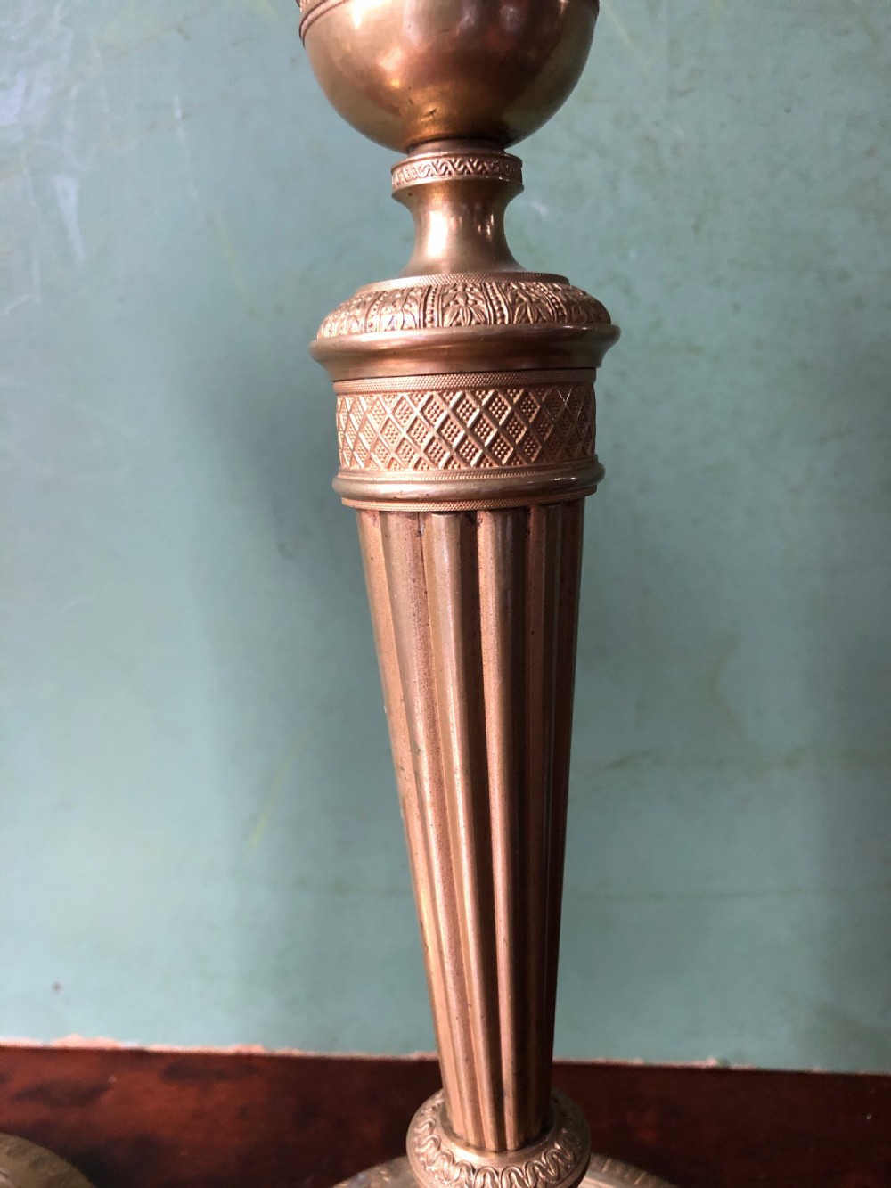 A pair of early 19th-century French Charles X period gilded bronze ormolu candlesticks with fluted columns and detailed engine-turned bases. View XI