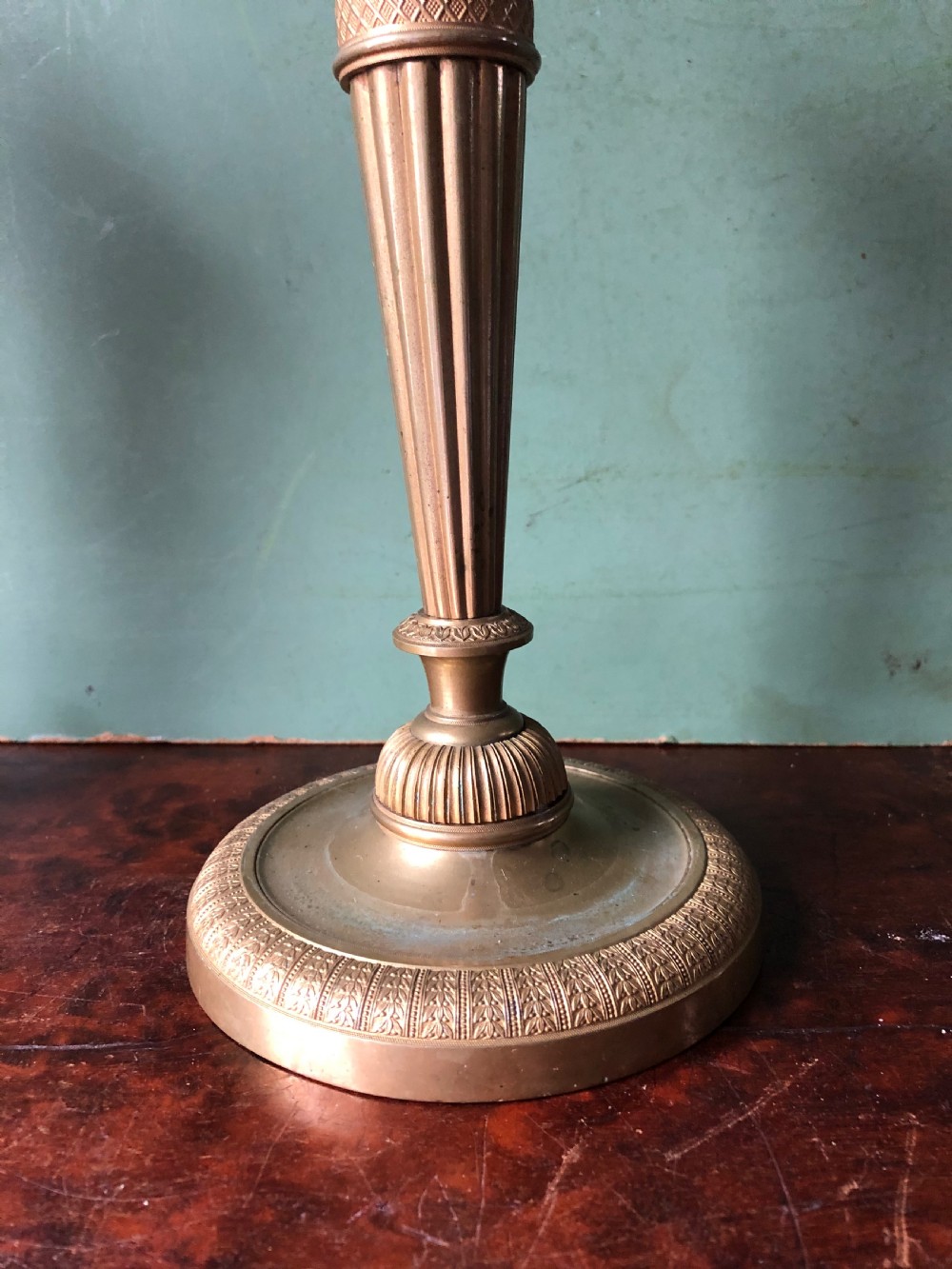A pair of early 19th-century French Charles X period gilded bronze ormolu candlesticks with fluted columns and detailed engine-turned bases. View XII