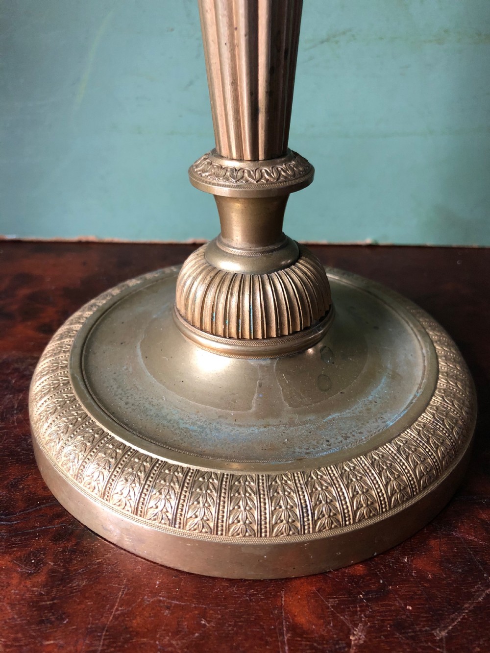 A pair of early 19th-century French Charles X period gilded bronze ormolu candlesticks with fluted columns and detailed engine-turned bases. View XIV