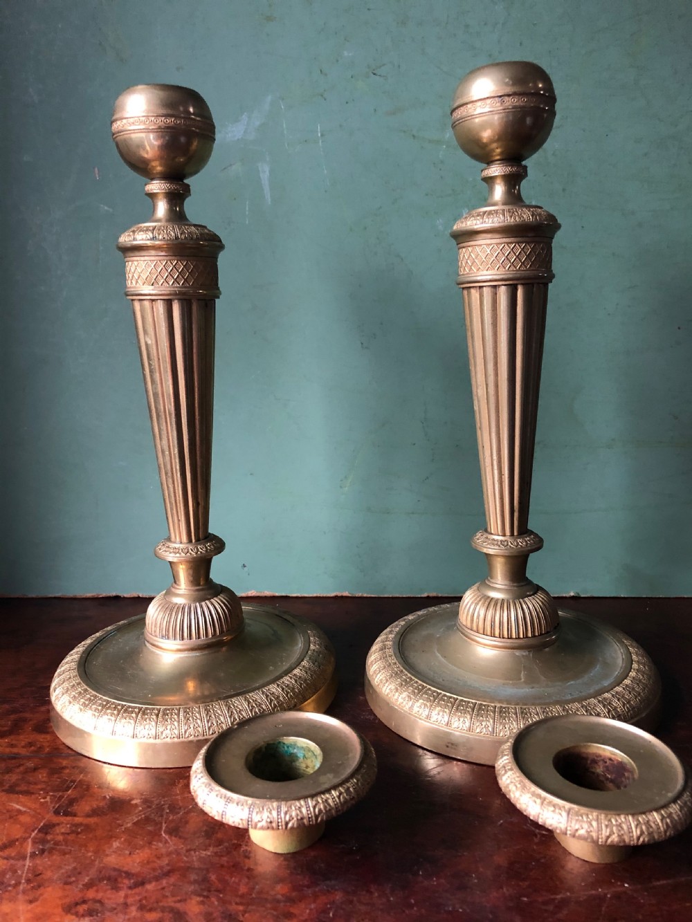 A pair of early 19th-century French Charles X period gilded bronze ormolu candlesticks with fluted columns and detailed engine-turned bases. View XV