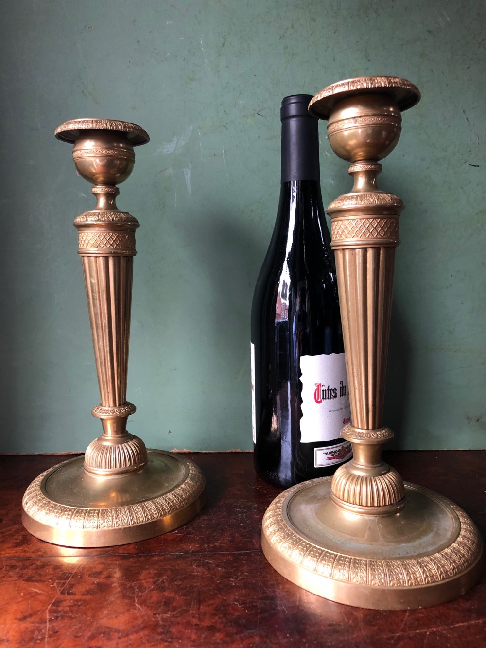 A pair of early 19th-century French Charles X period gilded bronze ormolu candlesticks with fluted columns and detailed engine-turned bases. View XVII