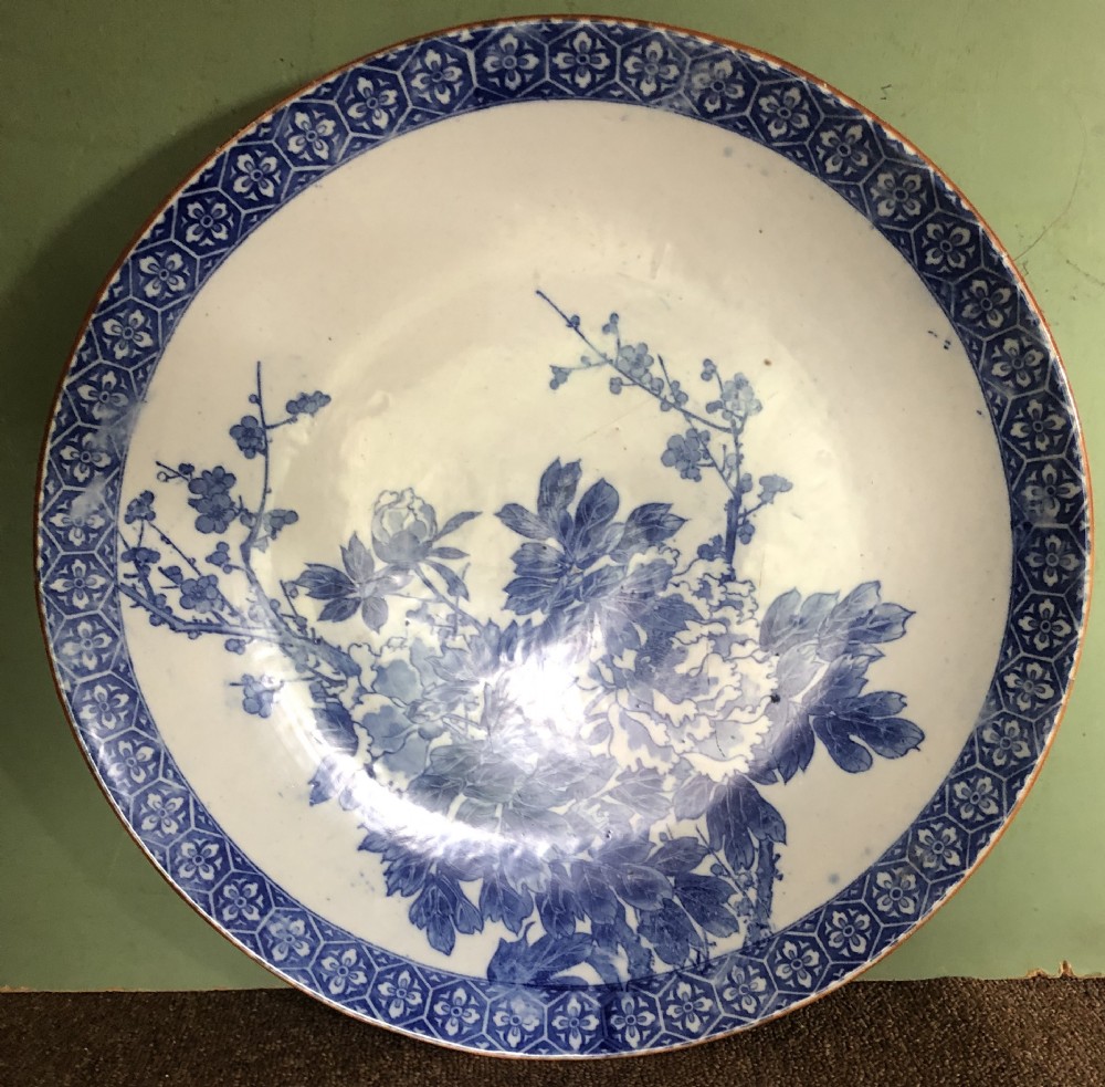 Late C19th Japanese Meiji period Arita porcelain charger with blue and white floral decoration.