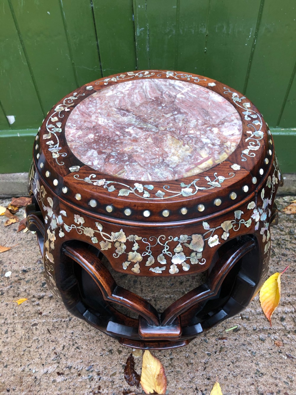 A nineteenth-century Chinese dark hongmu drum-shaped stool decorated with mother-of-pearl floral inlay and carved openwork sides. View II