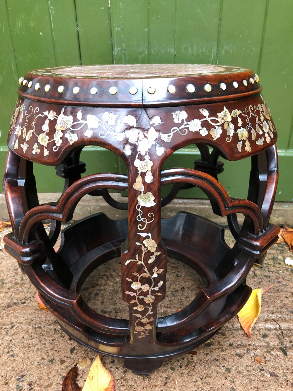A nineteenth-century Chinese dark hongmu drum-shaped stool decorated with mother-of-pearl floral inlay and carved openwork sides. View III