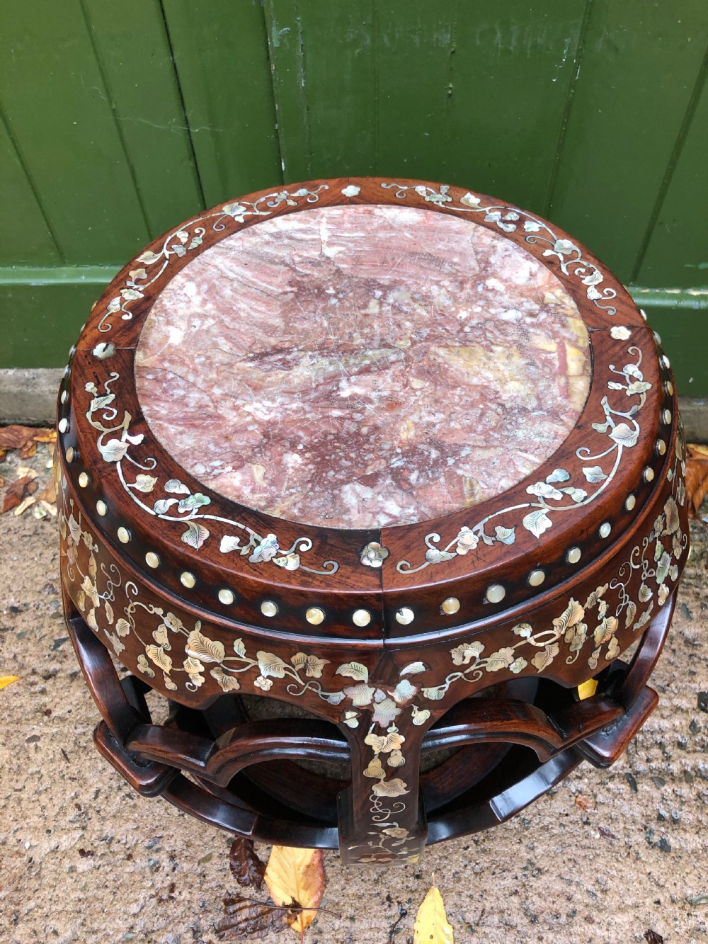 A nineteenth-century Chinese dark hongmu drum-shaped stool decorated with mother-of-pearl floral inlay and carved openwork sides. View IV