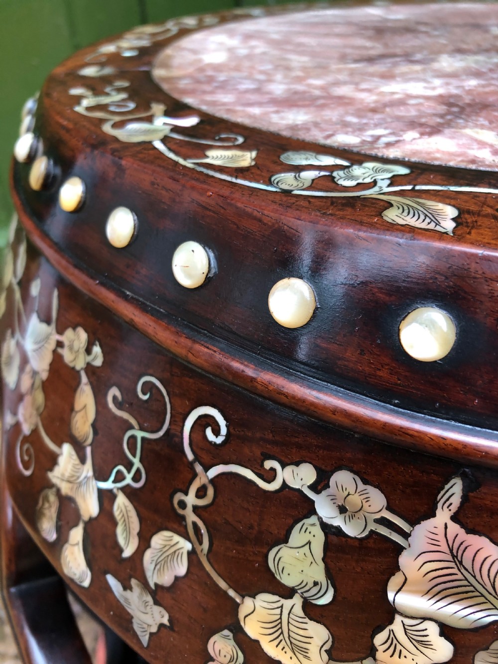 A nineteenth-century Chinese dark hongmu drum-shaped stool decorated with mother-of-pearl floral inlay and carved openwork sides. View V