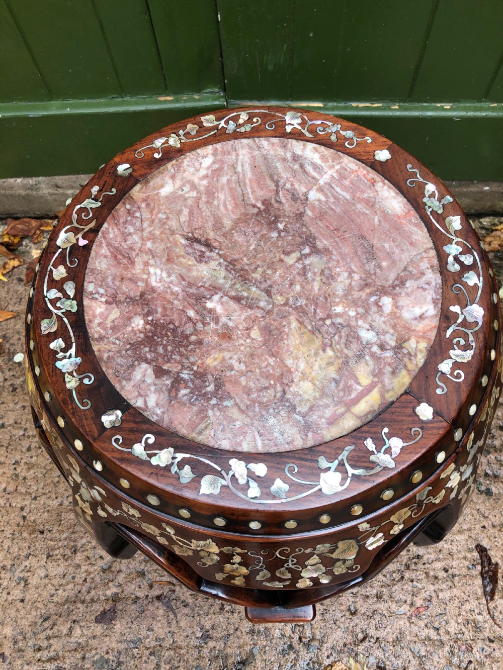 A nineteenth-century Chinese dark hongmu drum-shaped stool decorated with mother-of-pearl floral inlay and carved openwork sides. View VIII