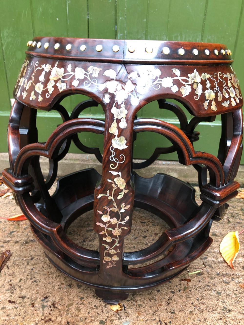 A nineteenth-century Chinese dark hongmu drum-shaped stool decorated with mother-of-pearl floral inlay and carved openwork sides. View XI