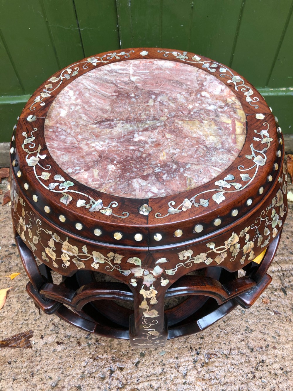 A nineteenth-century Chinese dark hongmu drum-shaped stool decorated with mother-of-pearl floral inlay and carved openwork sides. View XII