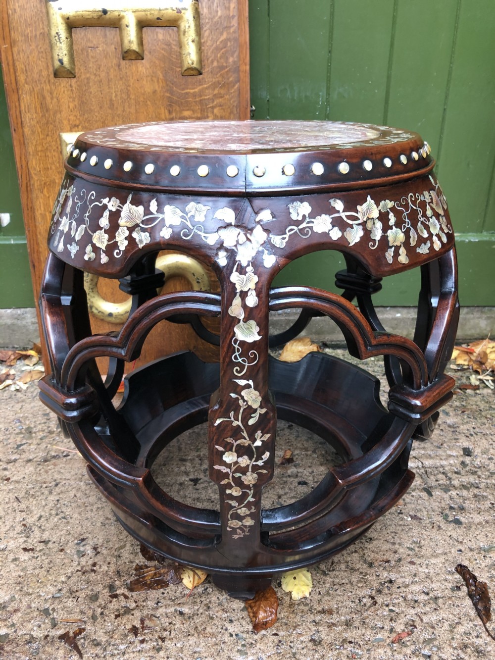 A nineteenth-century Chinese dark hongmu drum-shaped stool decorated with mother-of-pearl floral inlay and carved openwork sides. View XIII