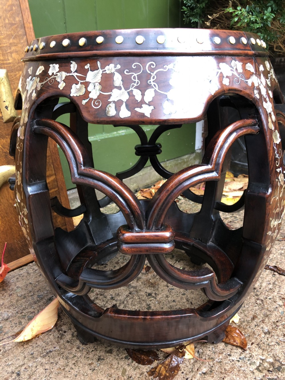 A nineteenth-century Chinese dark hongmu drum-shaped stool decorated with mother-of-pearl floral inlay and carved openwork sides. View XV