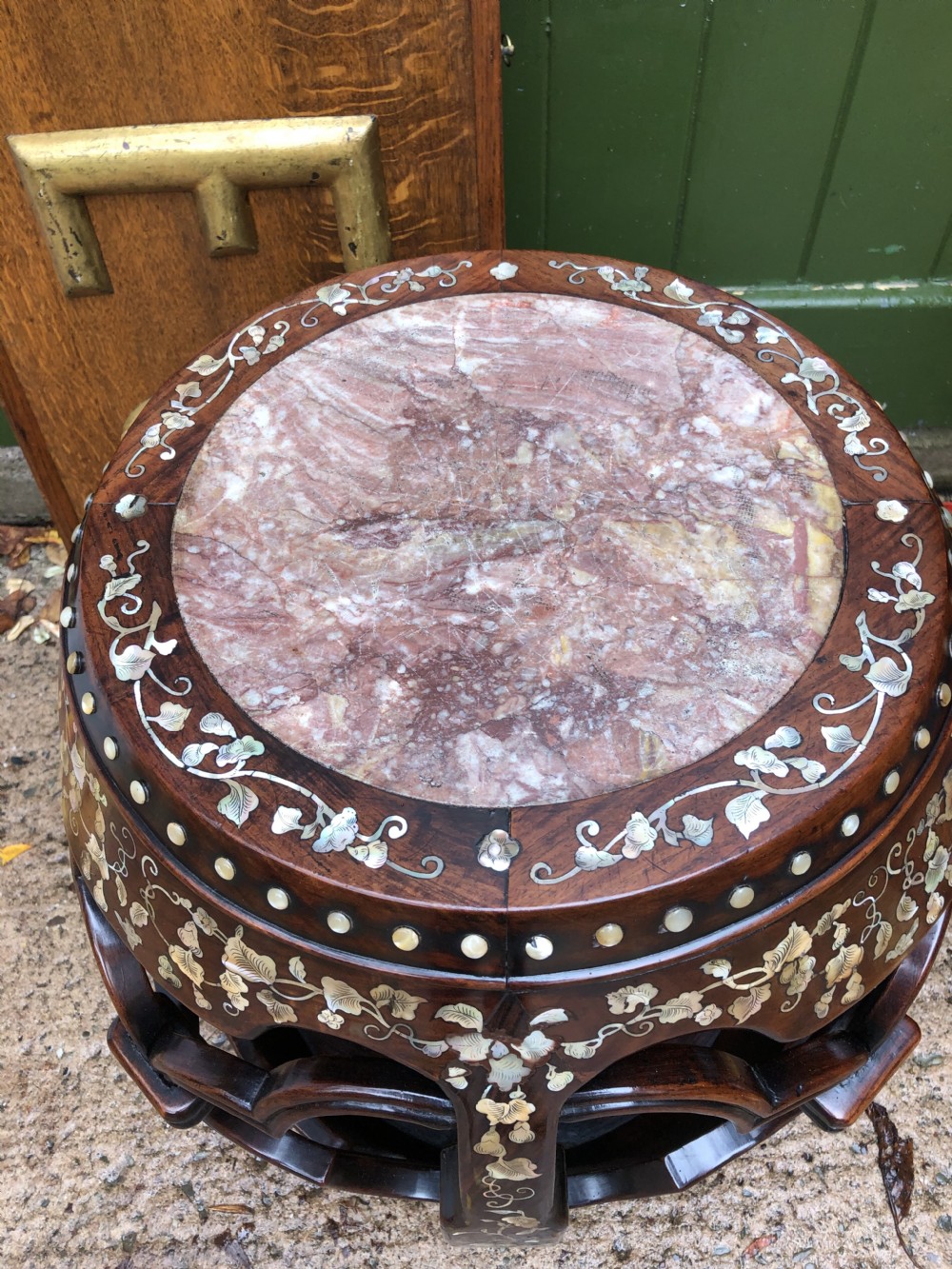 A nineteenth-century Chinese dark hongmu drum-shaped stool decorated with mother-of-pearl floral inlay and carved openwork sides. View XVI