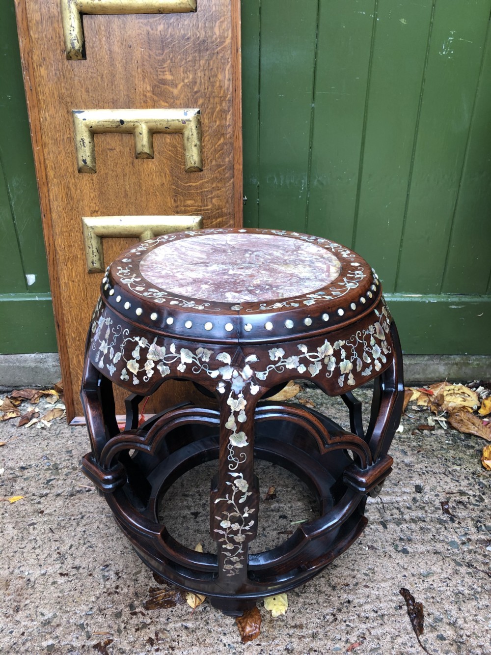 A nineteenth-century Chinese dark hongmu drum-shaped stool decorated with mother-of-pearl floral inlay and carved openwork sides. View XVII
