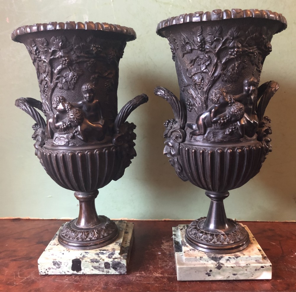 Pair of mid C19th Italian classical design bronze vases decorated with Bacchanalian scenes .