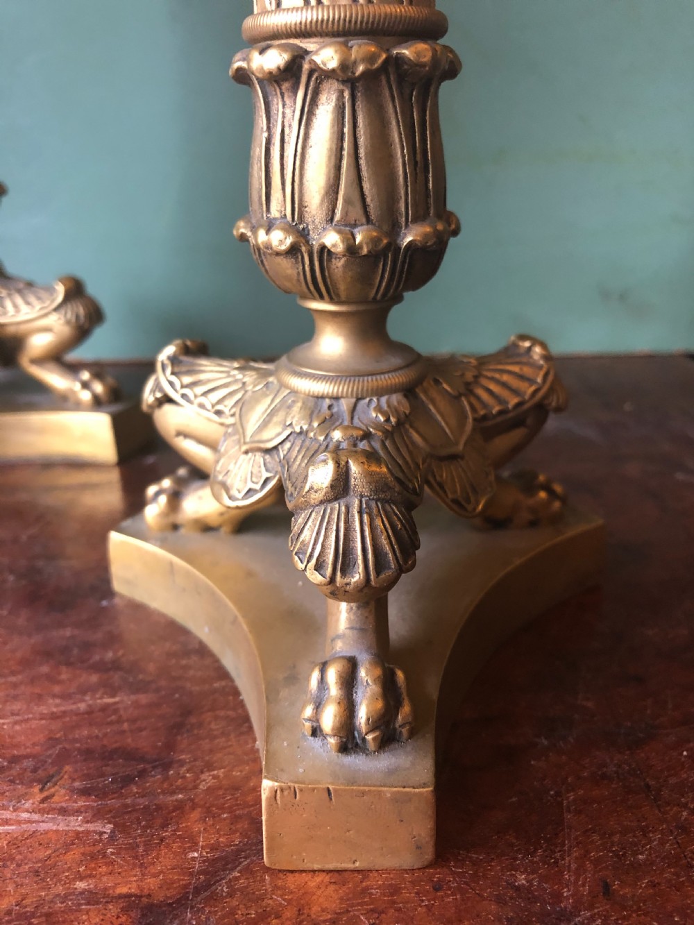 A pair of early nineteenth-century French Charles X gilt bronze candelabras featuring fluted columns, ornate scrolled arms, and decorative leaf motifs. View VI