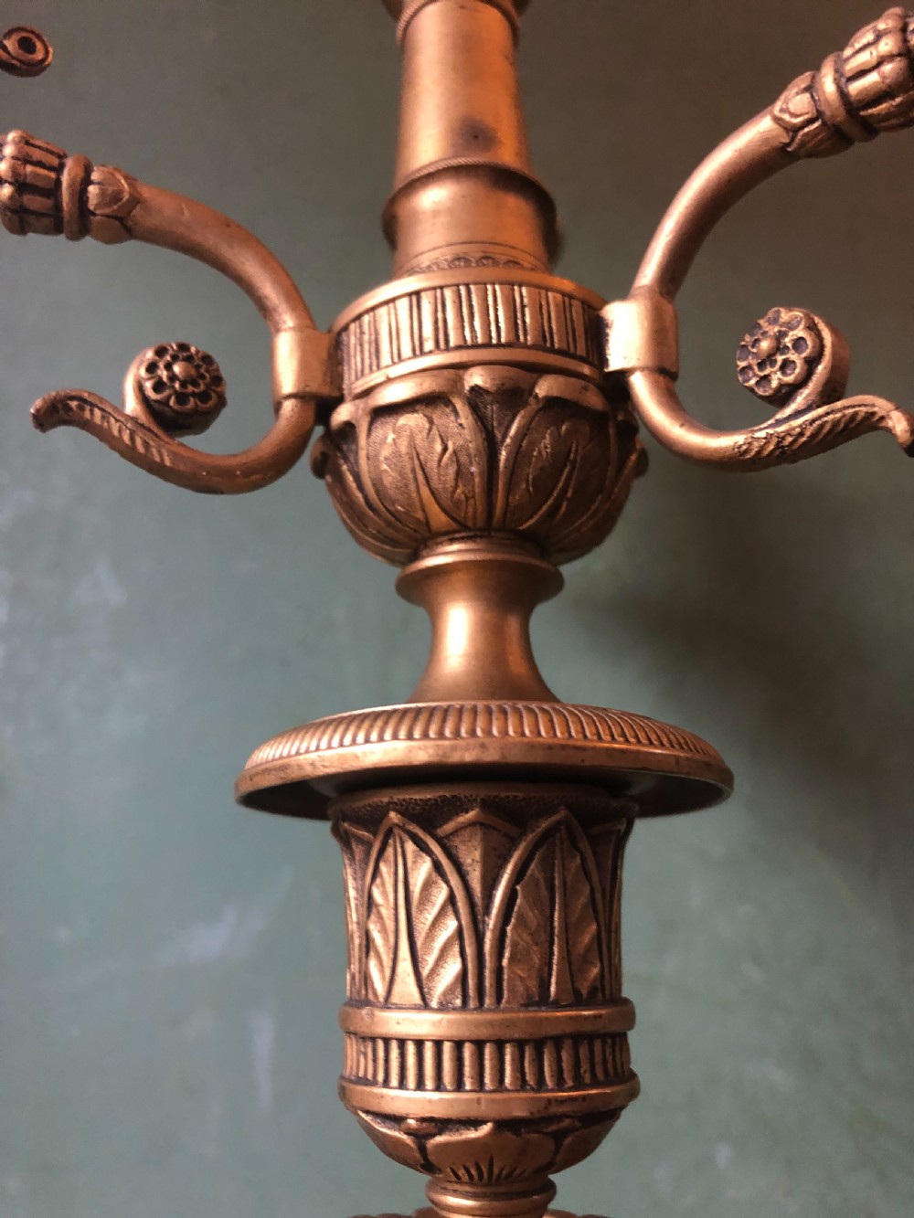 A pair of early nineteenth-century French Charles X gilt bronze candelabras featuring fluted columns, ornate scrolled arms, and decorative leaf motifs. View VIII