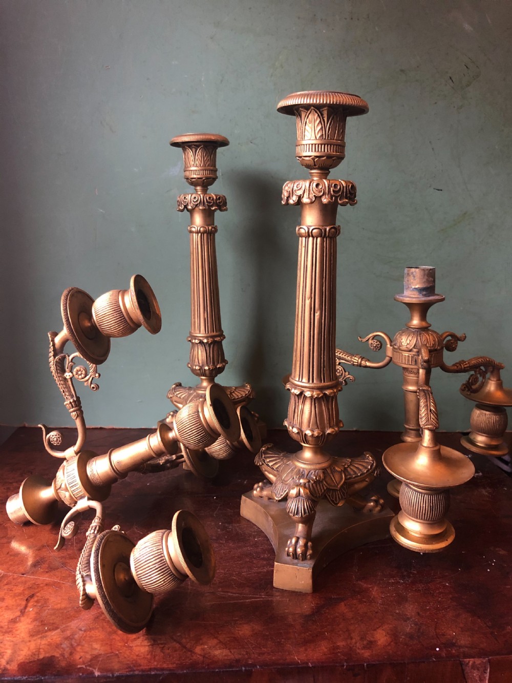 A pair of early nineteenth-century French Charles X gilt bronze candelabras featuring fluted columns, ornate scrolled arms, and decorative leaf motifs. View XII