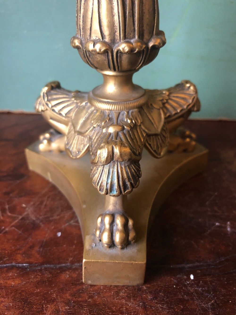 A pair of early nineteenth-century French Charles X gilt bronze candelabras featuring fluted columns, ornate scrolled arms, and decorative leaf motifs. View XVII