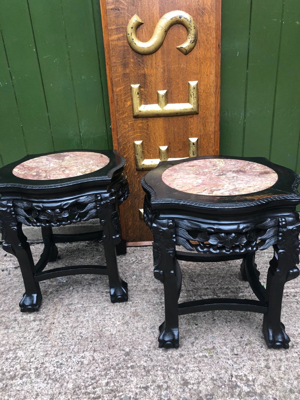 Pair of ebonised wooden side tables featuring pierced floral carvings and circular pink marble inset tops. View VI