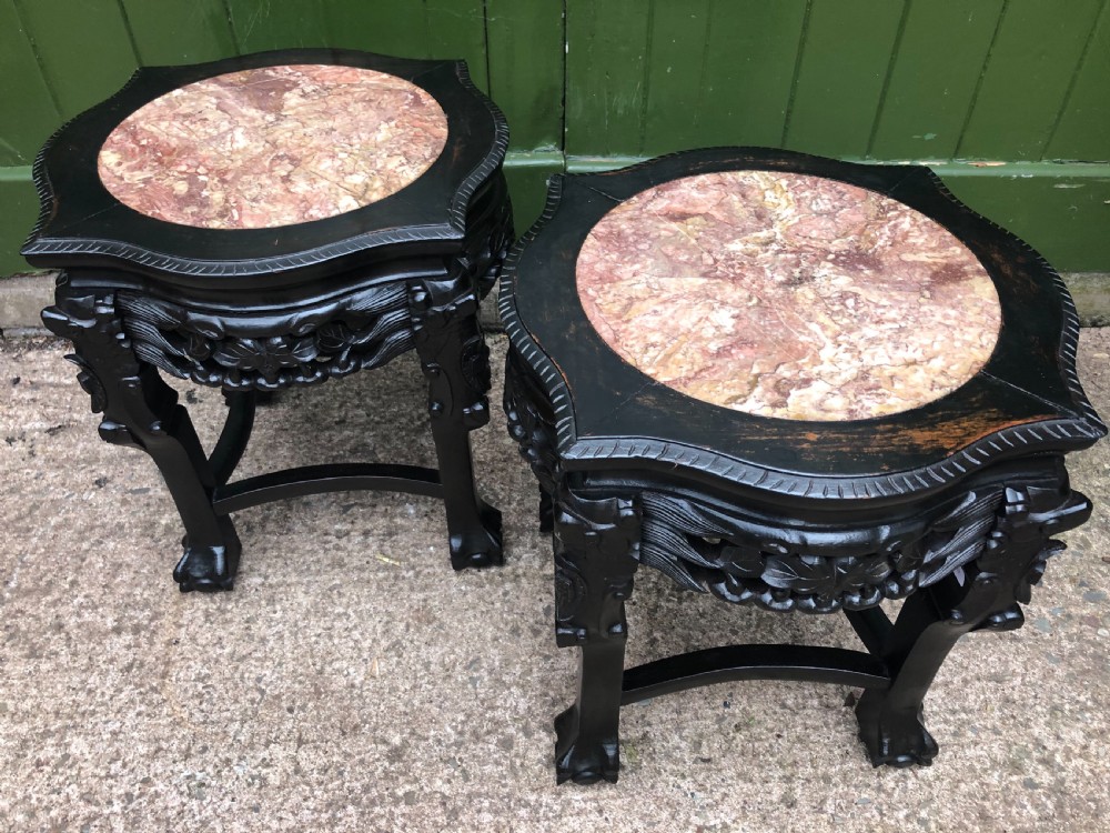 Pair of ebonised wooden side tables featuring pierced floral carvings and circular pink marble inset tops. View XI