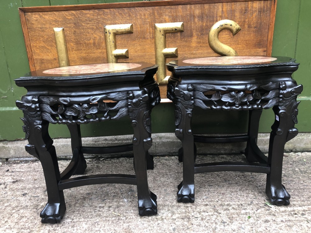 Pair of ebonised wooden side tables featuring pierced floral carvings and circular pink marble inset tops. View XIII