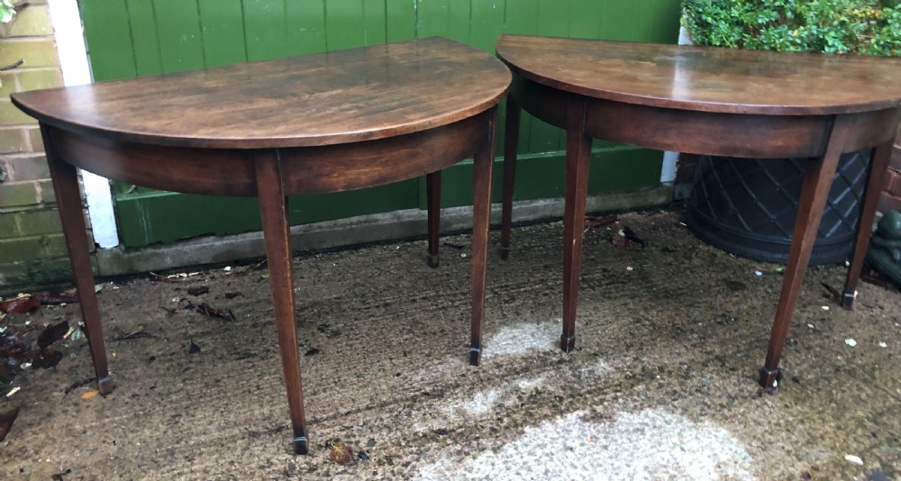 Pair of C18th George III period Cuban mahogany demi-lune tables .