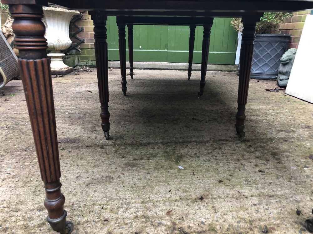 Early C19th late George III period mahogany extending dining table of unusual format . View IV