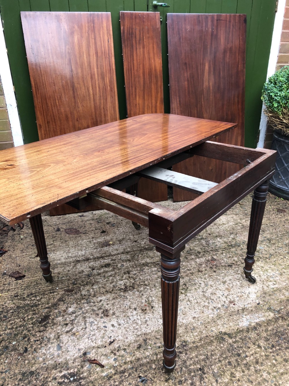 Early C19th late George III period mahogany extending dining table of unusual format . View X