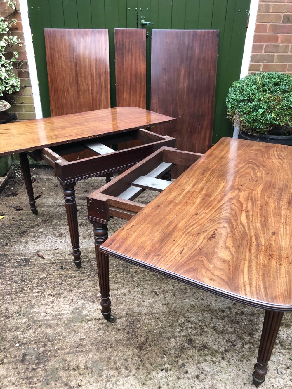 Early C19th late George III period mahogany extending dining table of unusual format . View XI
