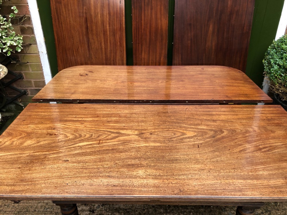 Early C19th late George III period mahogany extending dining table of unusual format . View XVI