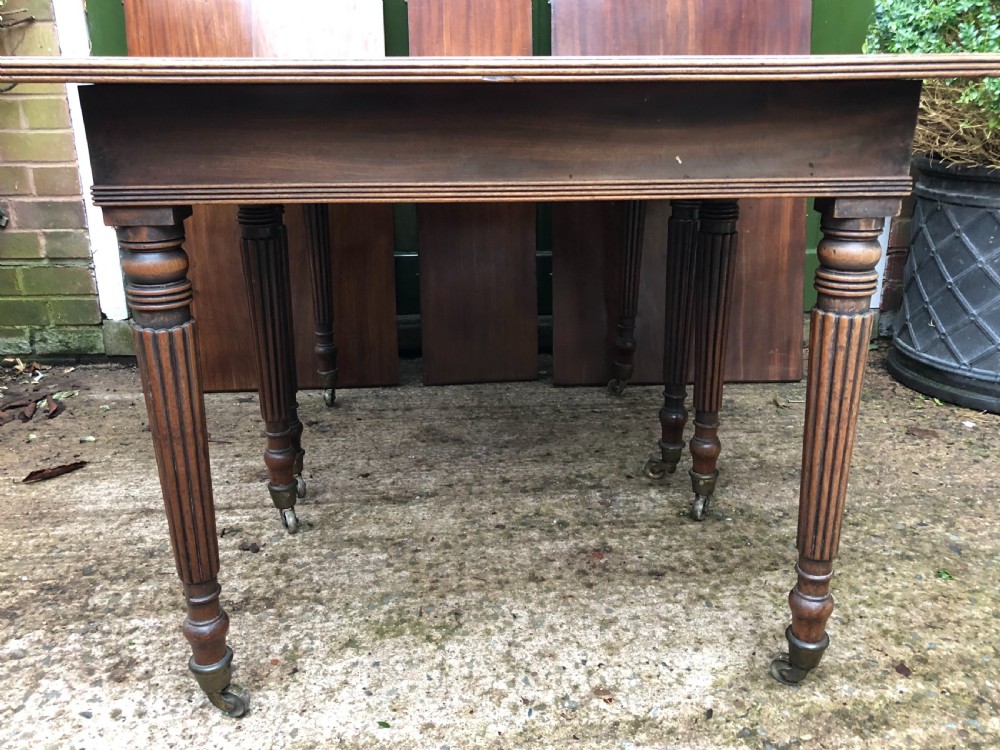 Early C19th late George III period mahogany extending dining table of unusual format . View XVII