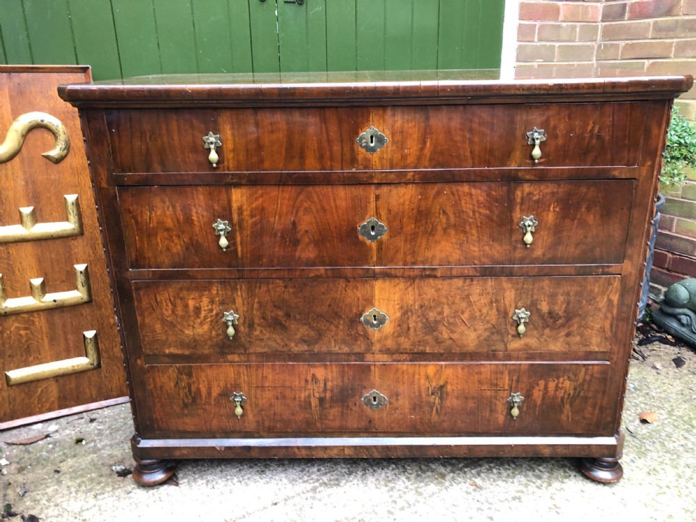 A late eighteenth-century Continental walnut commode chest featuring four long drawers with brass handles and brass escutcheons. View II