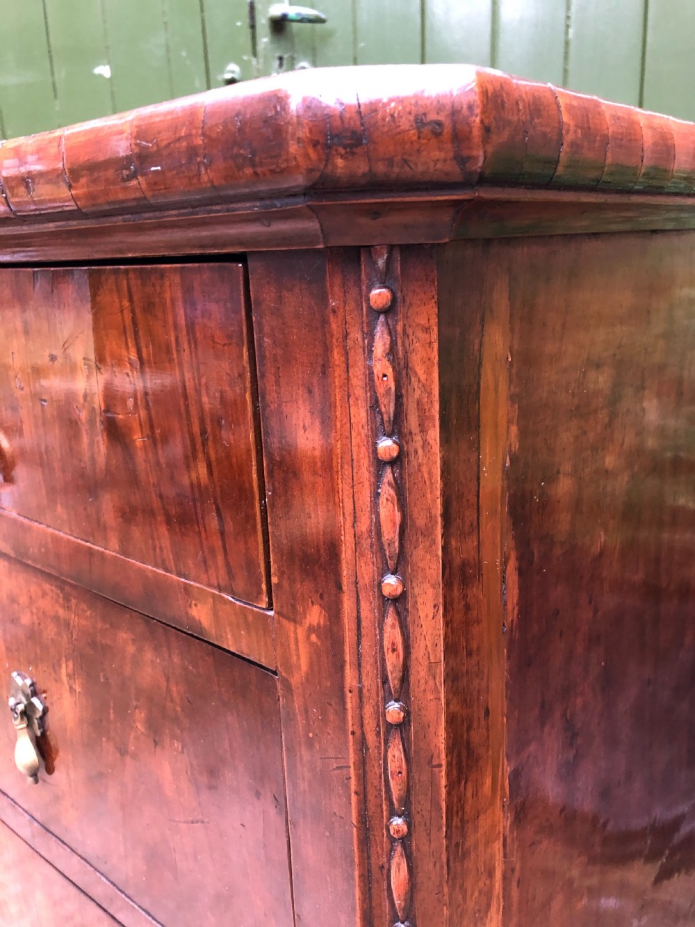 A late eighteenth-century Continental walnut commode chest featuring four long drawers with brass handles and brass escutcheons. View III