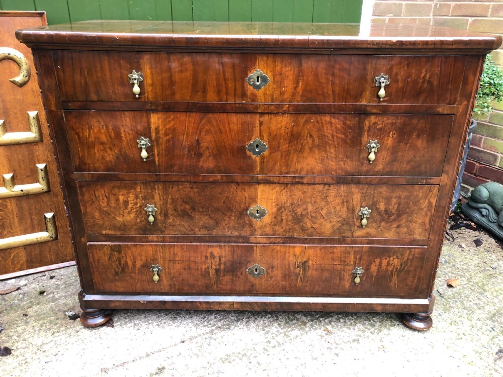 A late eighteenth-century Continental walnut commode chest featuring four long drawers with brass handles and brass escutcheons. View X
