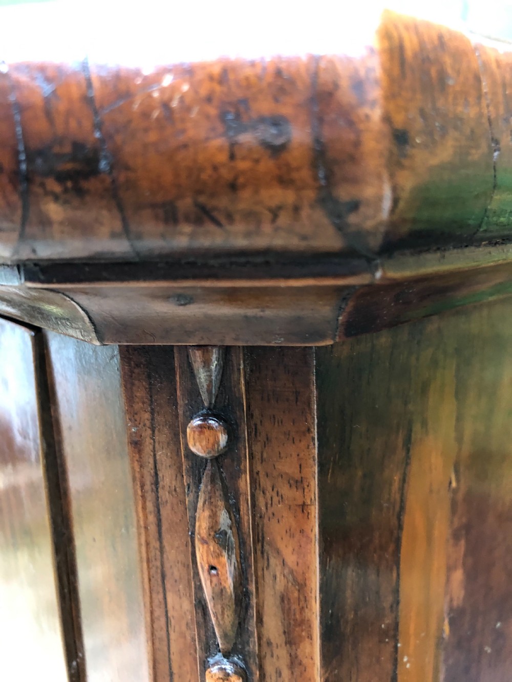 A late eighteenth-century Continental walnut commode chest featuring four long drawers with brass handles and brass escutcheons. View XVIII