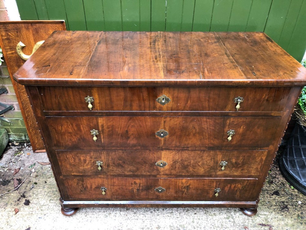 A late eighteenth-century Continental walnut commode chest featuring four long drawers with brass handles and brass escutcheons. View XXI
