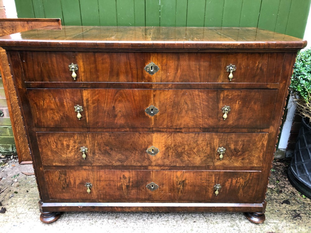 A late eighteenth-century Continental walnut commode chest featuring four long drawers with brass handles and brass escutcheons. View XXIII