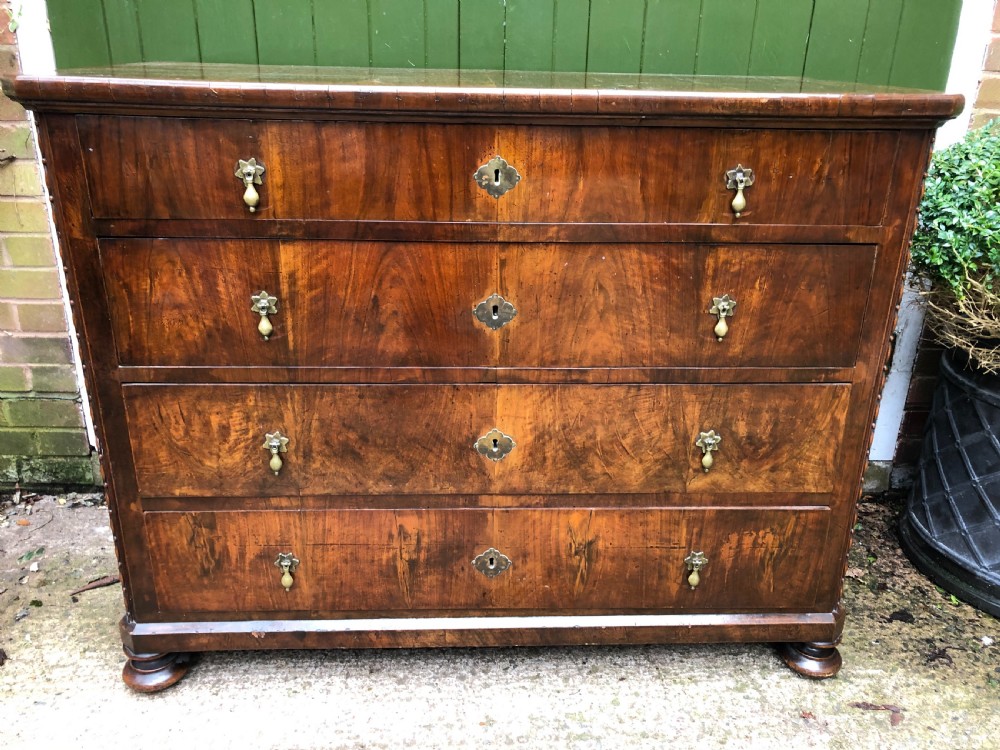 A late eighteenth-century Continental walnut commode chest featuring four long drawers with brass handles and brass escutcheons. View XXV