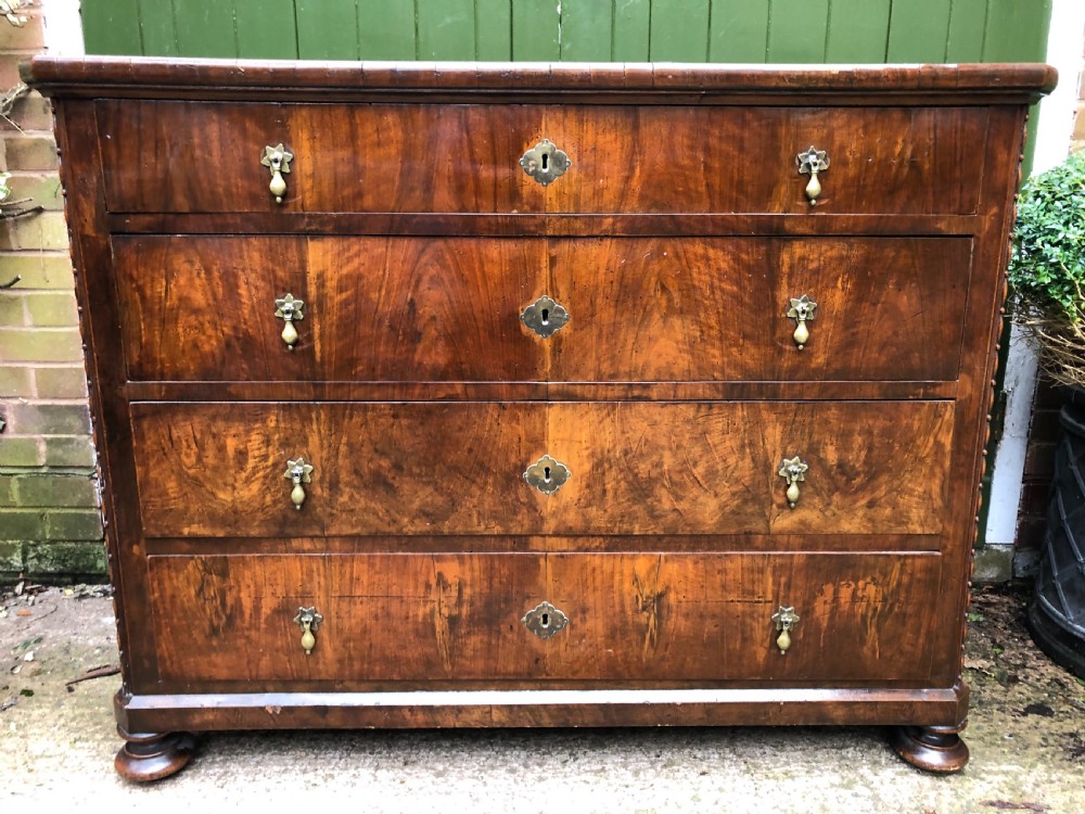 A late eighteenth-century Continental walnut commode chest featuring four long drawers with brass handles and brass escutcheons. View XXVIII