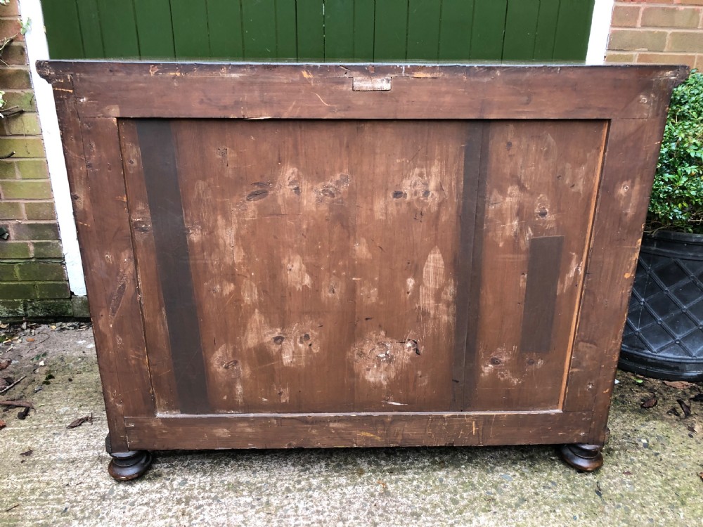 A late eighteenth-century Continental walnut commode chest featuring four long drawers with brass handles and brass escutcheons. View XXIX