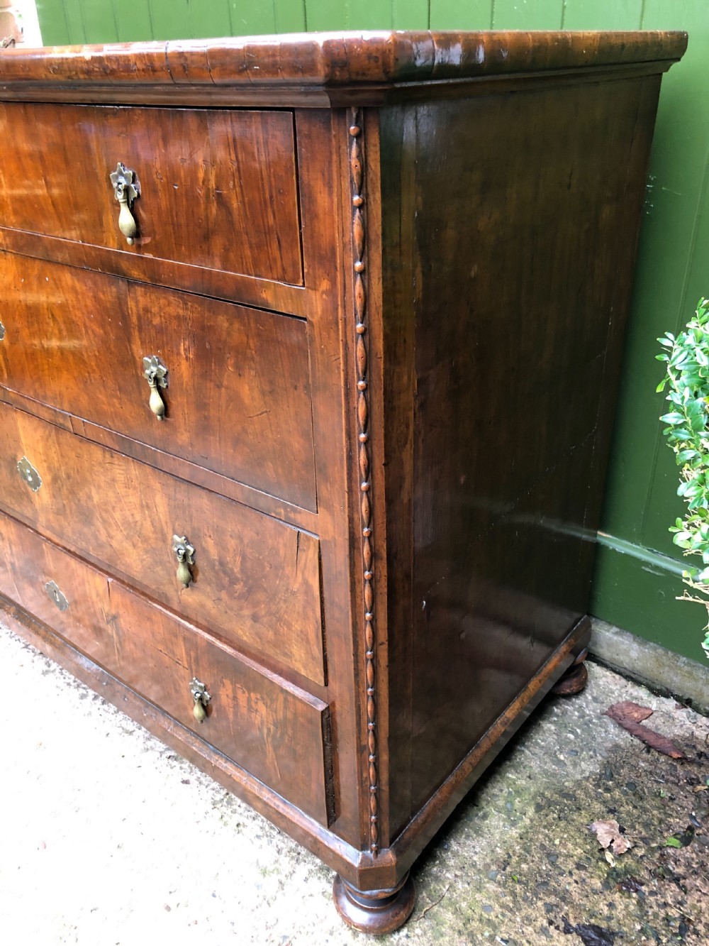 A late eighteenth-century Continental walnut commode chest featuring four long drawers with brass handles and brass escutcheons. View XXXI