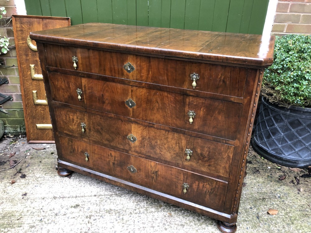A late eighteenth-century Continental walnut commode chest featuring four long drawers with brass handles and brass escutcheons. View XXXII