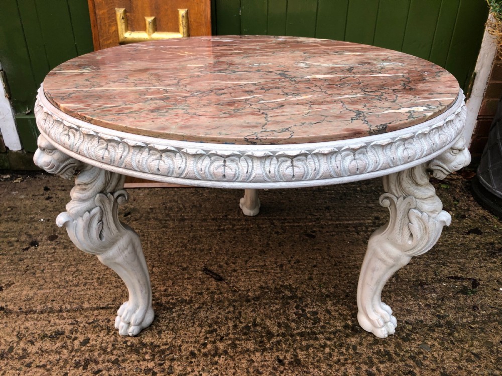 Late C19th decorated circular carved carved table with marble top on ancient Roman style lion monopodia supports.