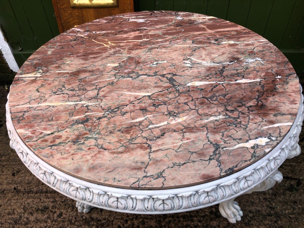 Late C19th decorated circular carved carved table with marble top on ancient Roman style lion monopodia supports. View II