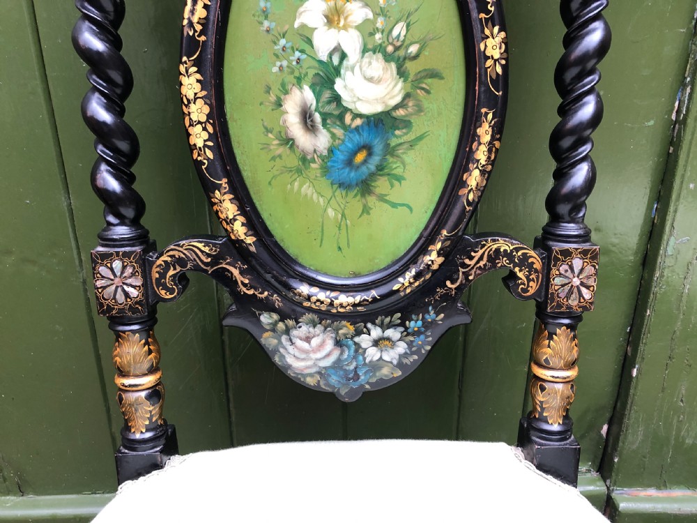 A pair of black lacquered Victorian bedroom chairs featuring oval back panels painted with floral motifs, mother-of-pearl inlay, barley twist legs, and light green upholstered seats. View XI